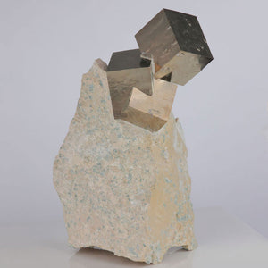 Tall pyrite crystal cluster on limestone