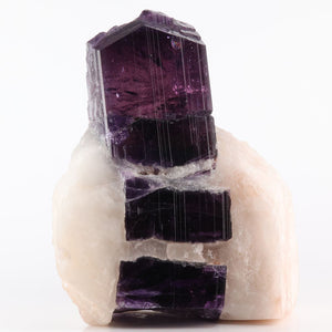 Purple Scapolite crystal on a white background