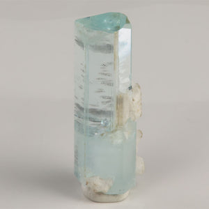 Side view of 7.08 gram aquamarine showing horizontal internal growth lines and clear crystal faces.