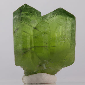 Green peridot crystal with ludwigite