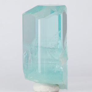 Crystal-like object with a light blue tint on a white background