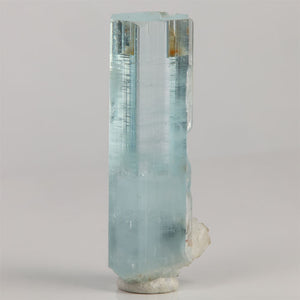 Side view of 10.68 gram aquamarine showing clear hexagonal faces and fine horizontal growth lines.