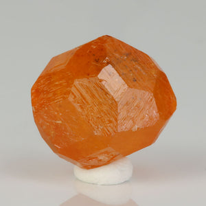 Bright orange garnet crystal specimen display