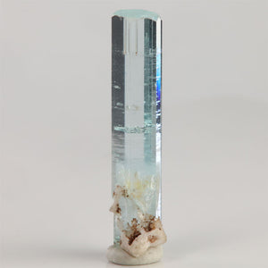 Slender aquamarine crystal from Shigar Mine Pakistan with clear reflective faces and a delicate icy-blue termination.
