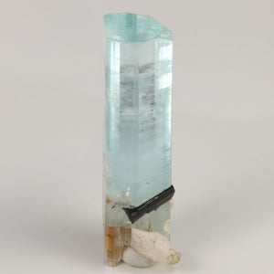 Side view of transparent Pakistani aquamarine showing internal growth lines and mineral inclusions.