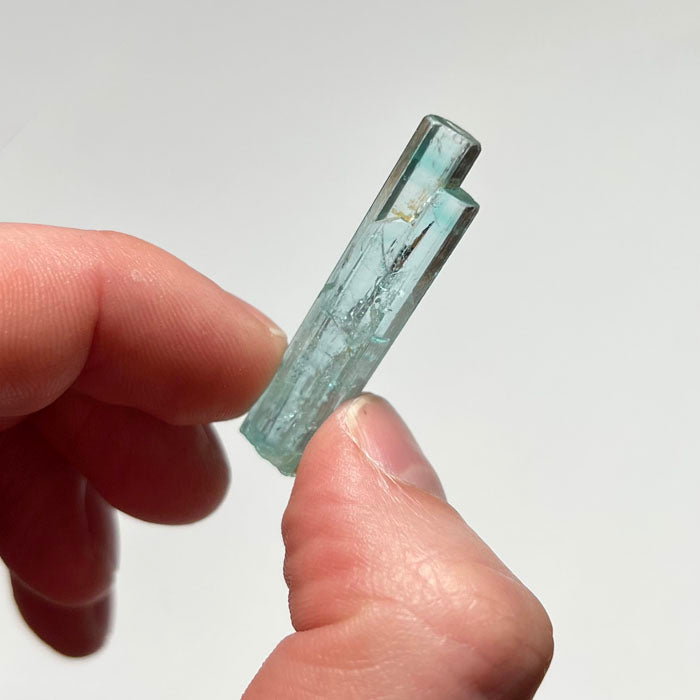 aquamarine beryl crystal in hand 