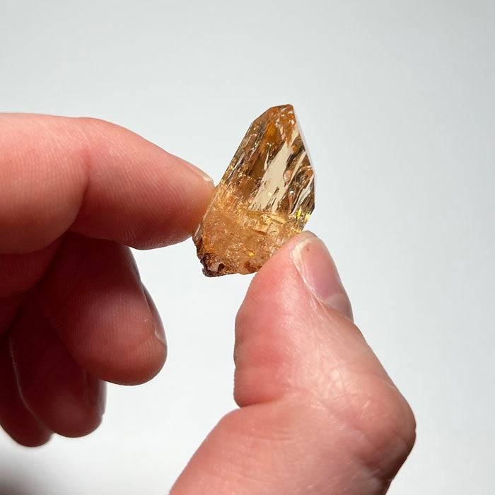 topaz crystal in hand for size comparison