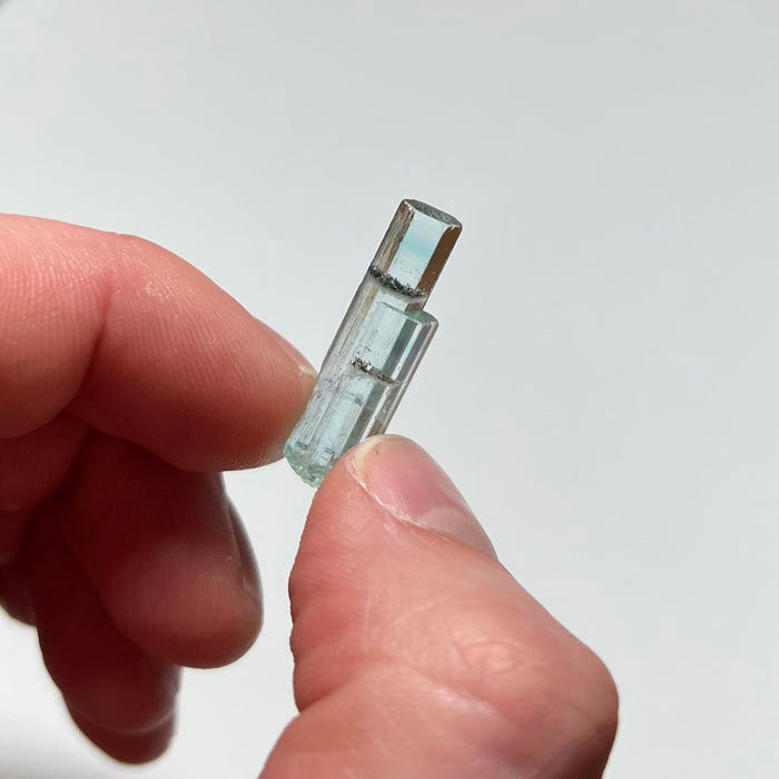 hand with beryl crystal for size 