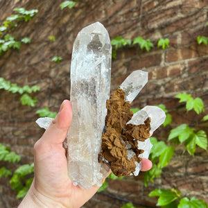 Large clear quartz crystals with hematite