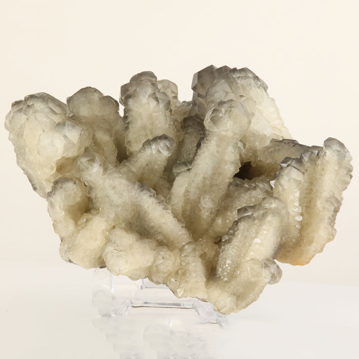 Clear calcite crystal cluster with gray zoning