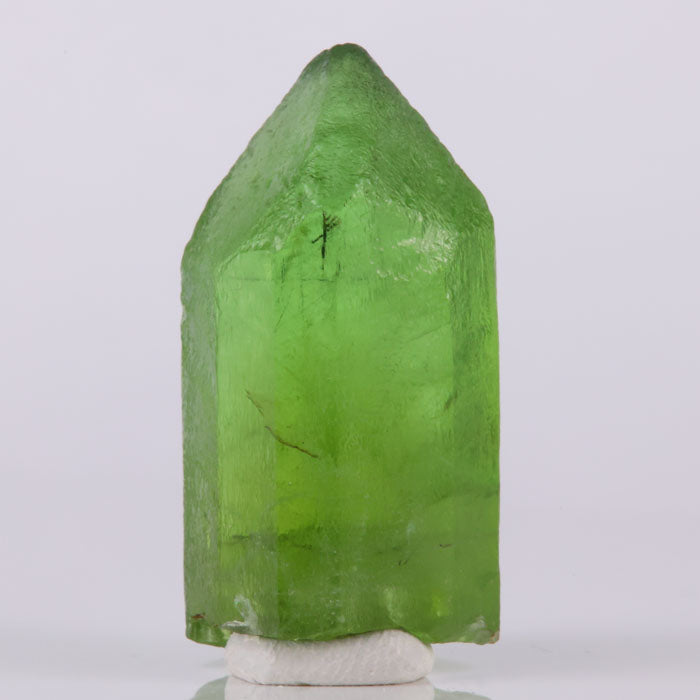 Green peridot crystal with strong color and transparency collector piece