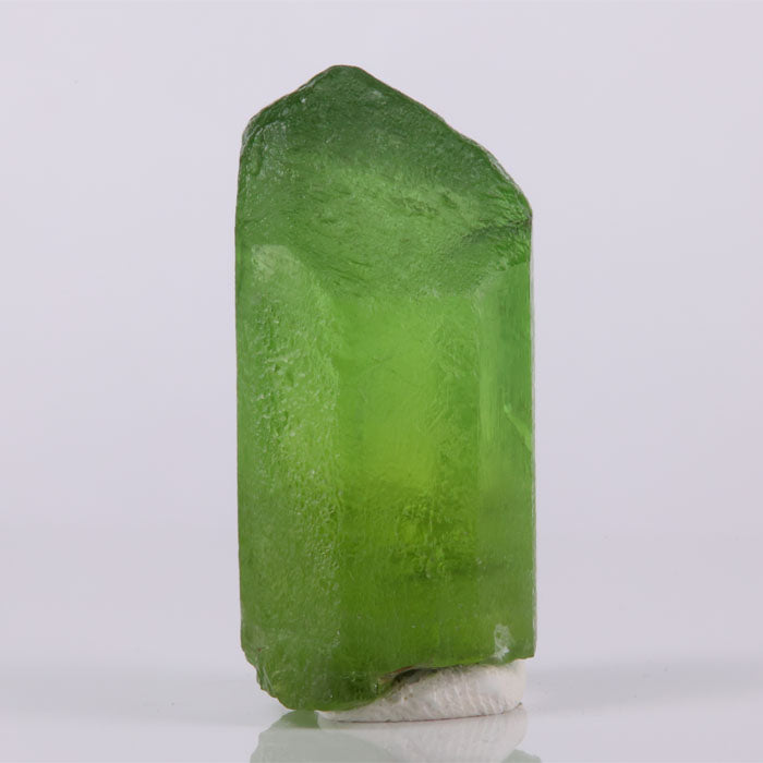 Vibrant green peridot crystal well formed natural mineral