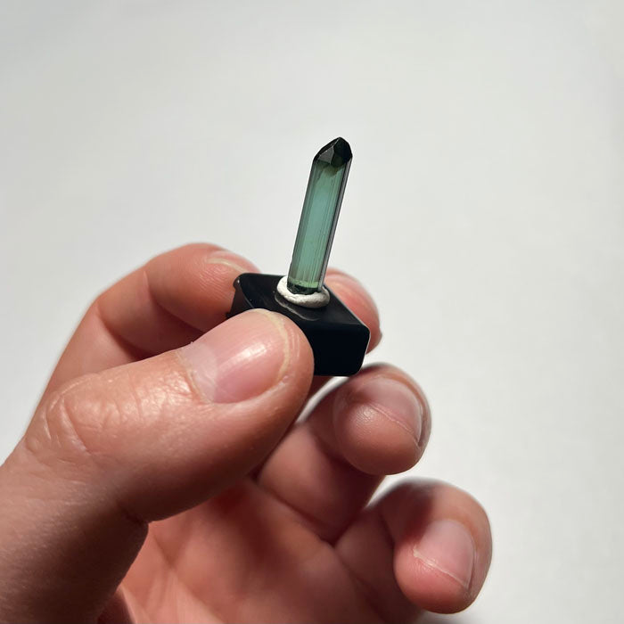 Green Tourmaline crystal prism on a white background