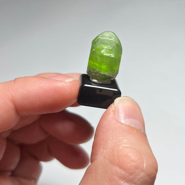 Green crystal on a gray background