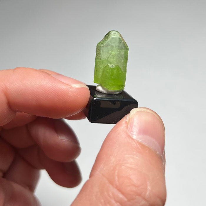 Green crystal on a gray background