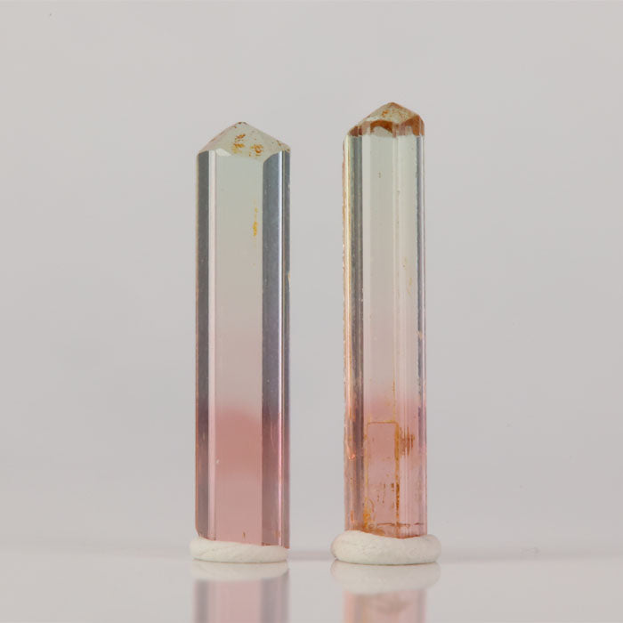 Pair of bi color tourmaline crystals slender matching specimens