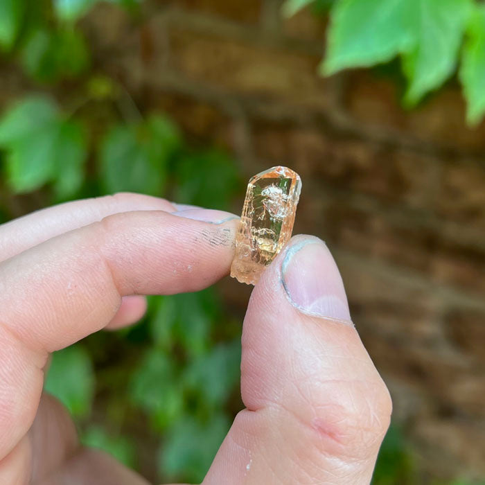 Raw topaz crystal from zambia orange pink peach