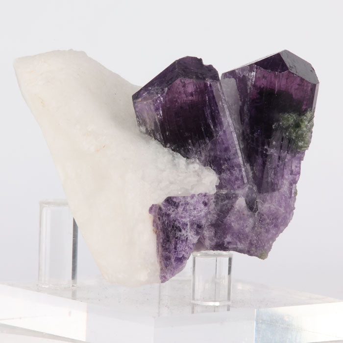 Purple Scapolite crystal on a white background