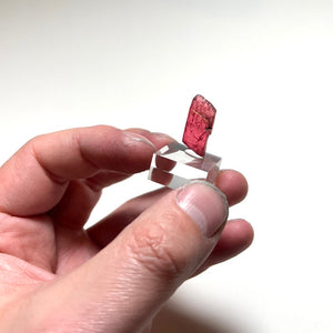 Pink rhodonite crystal with black inclusions