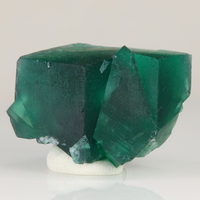 Natural daylight fluorescent Rogerley fluorite with dark green crystal centers and lighter transparent edges.