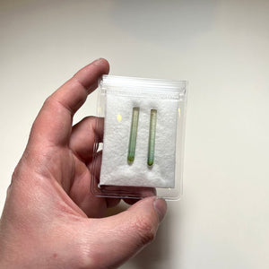 Slender green tourmaline crystals similar pair