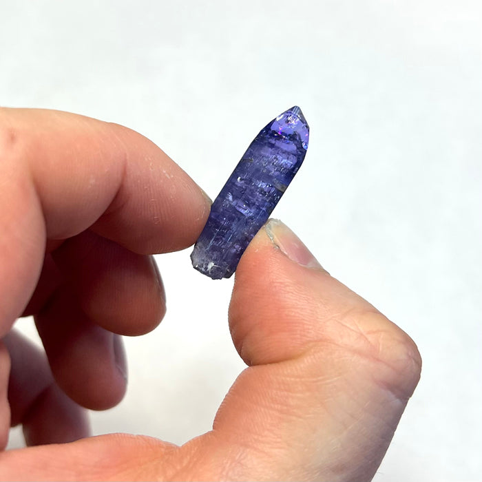 Tall purple tanzanite crystal specimen
