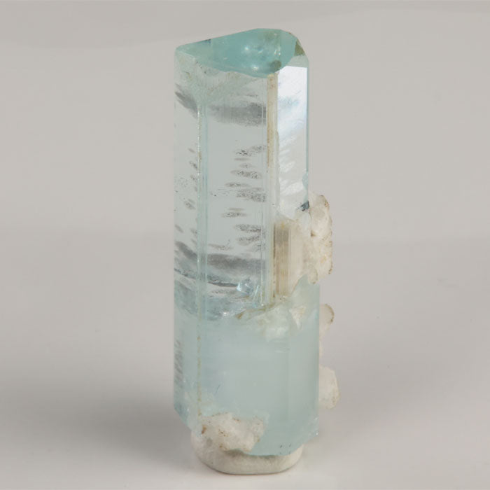 Side view of 7.08 gram aquamarine showing horizontal internal growth lines and clear crystal faces.