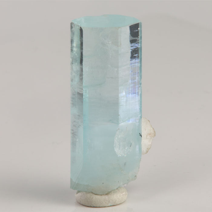 Reverse view of aquamarine from Skardu Valley featuring transparent upper faces and a frosted blue crystal base.