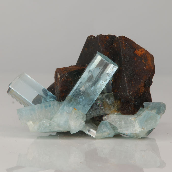 light blue beryl crystals with dark mineral contrast