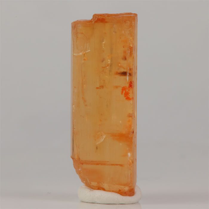 Brazilian topaz specimen with warm orange hues and broad crystal face