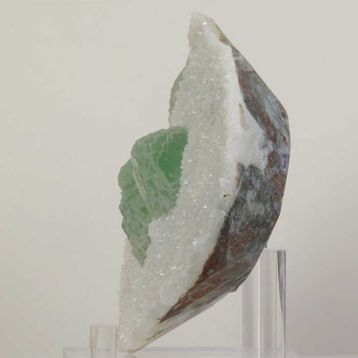 Large Chinese fluorite specimen with white druzy coating