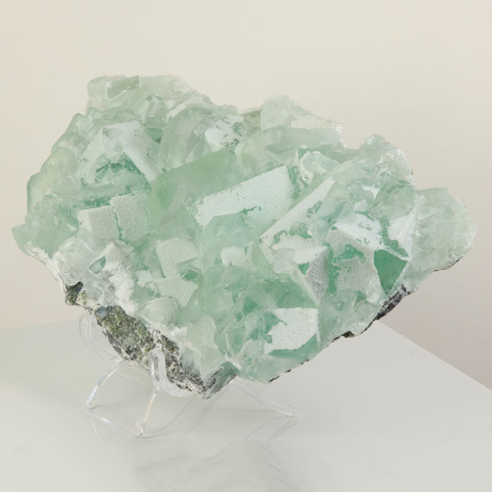 Pale green fluorite mineral cluster on matrix