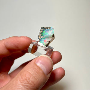 Natural Ethiopian opal specimen displaying bright green fire