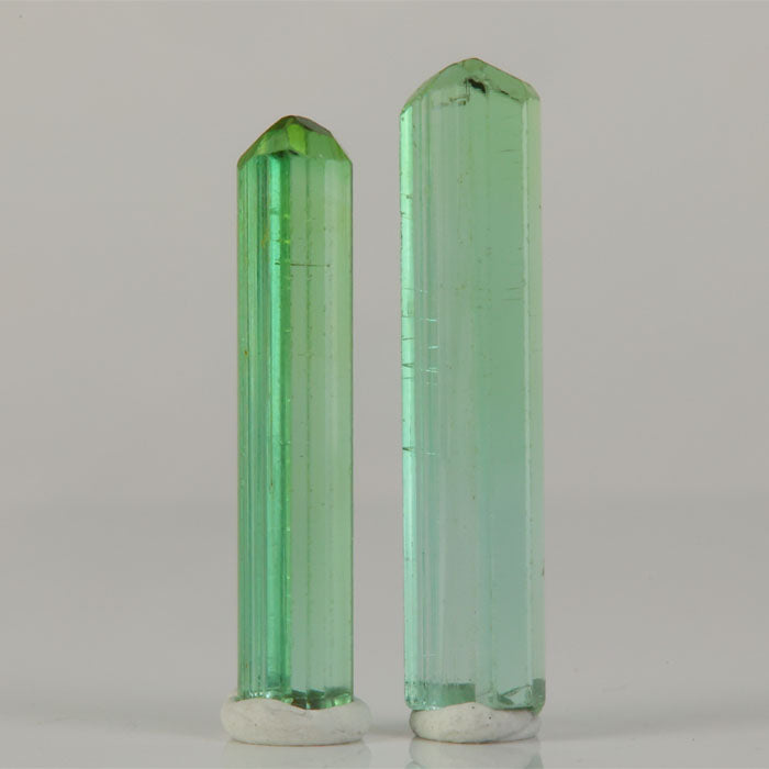 vivid green tourmaline crystals pair from congo elongated shape