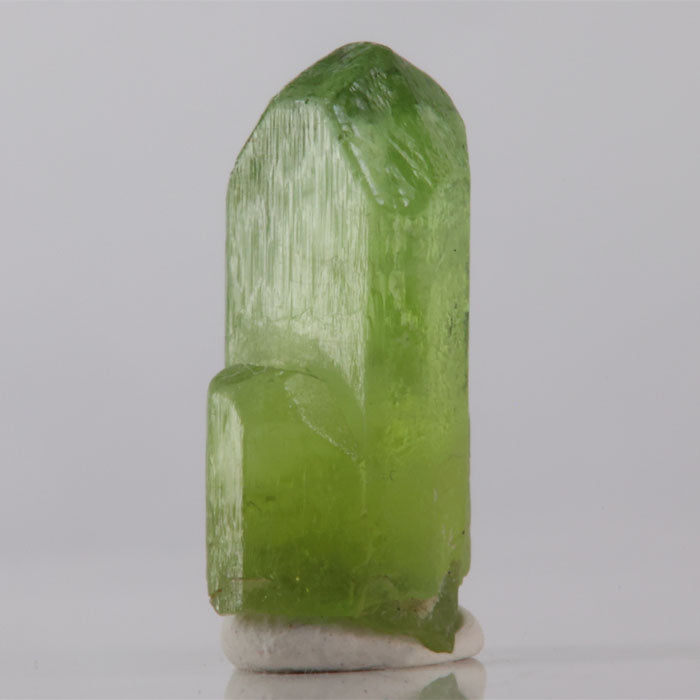 Green crystal on a gray background