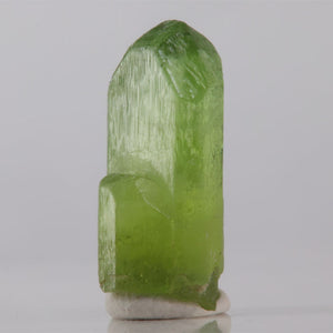 Green crystal on a gray background