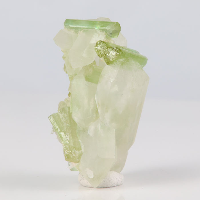 natural green tourmaline crystals on quartz