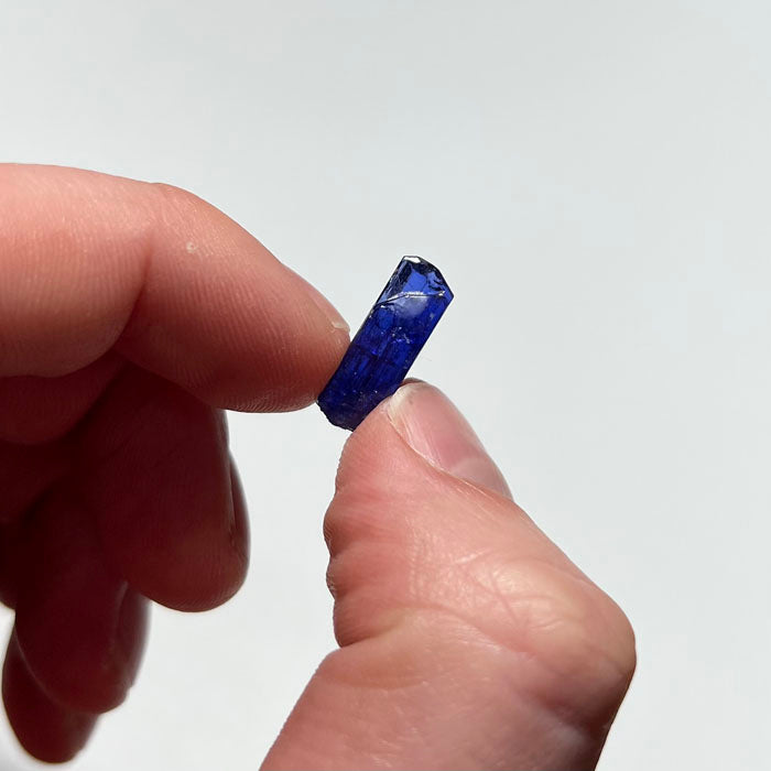 deep color crystal natural tanzanite in hand