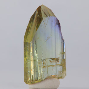 Tanzanite Crystal with multicolored facets on a white background