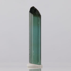 Zimbabwe Green Tourmaline crystal with a black top on a white background