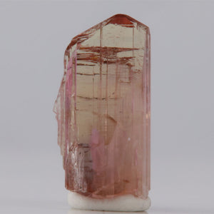 Tanzanite Crystal with pink and white colors on a gray background