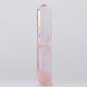 Natural Pink Topaz Crystal tower with pink and white coloration on a light gray background