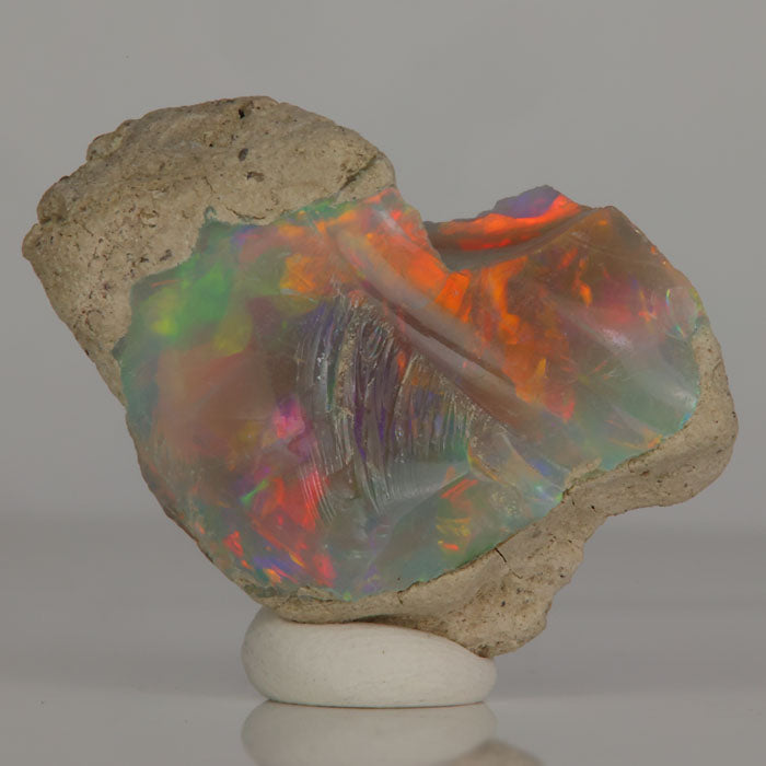 dark base Ethiopian opal with red green orange play of color