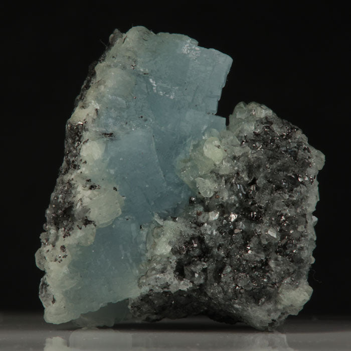 Blocky blue prehnite crystals displaying strong UV reaction