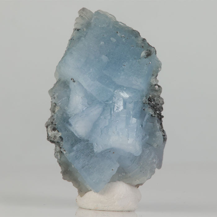 Fluorescent prehnite glowing under longwave UV light