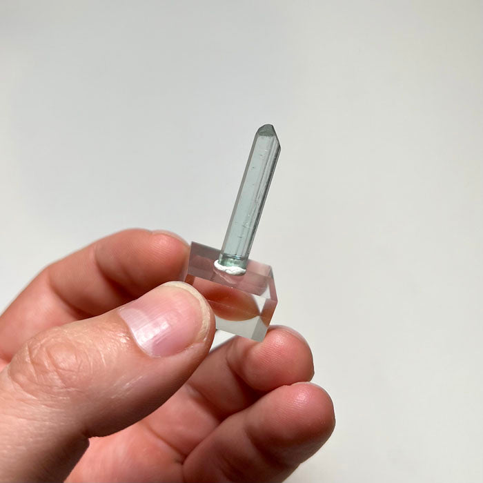 Elongated blue Tourmaline crystal with natural termination