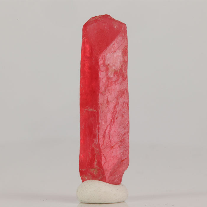 Elongated pink rhodonite crystal specimen from Brazil with slender form