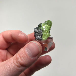 diopside mineral specimen with dark graphite contrast