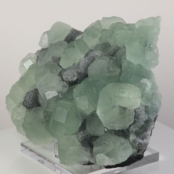 Green fluorite crystal cluster on sparkling matrix