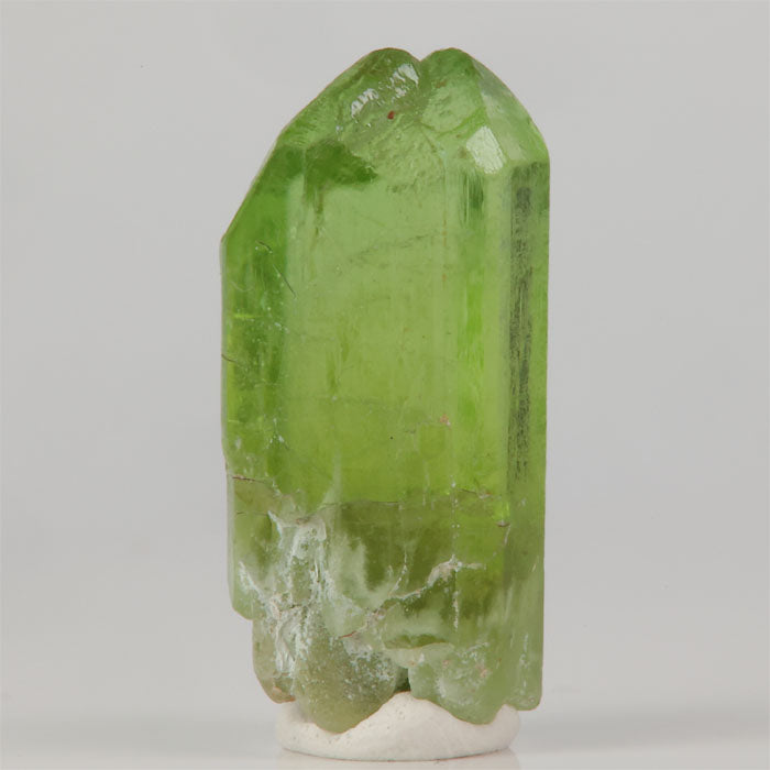 Green peridot crystal specimen from Pakistan with natural prism structure